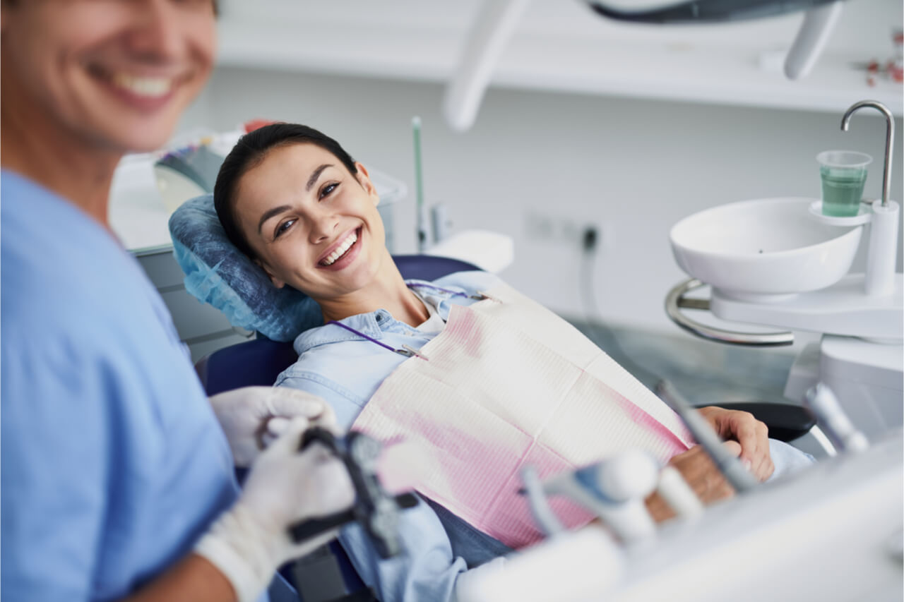 The woman visits her dentist to prevent tooth decay.